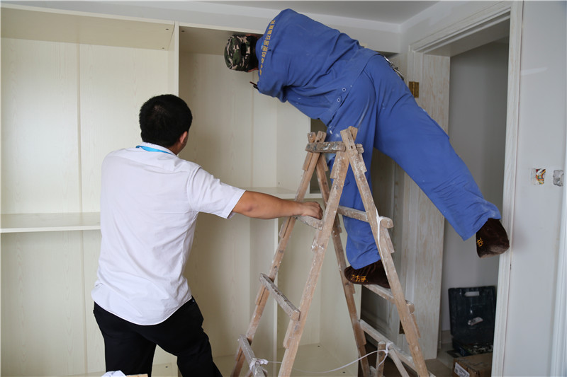 左右手家具安裝師傅彼此合作，完成家具安裝工作